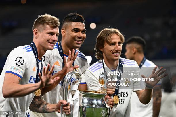 Real Madrid's German midfielder Toni Kroos, Real Madrid's Brazilian midfielder Casemiro and Real Madrid's Croatian midfielder Luka Modric pose with...