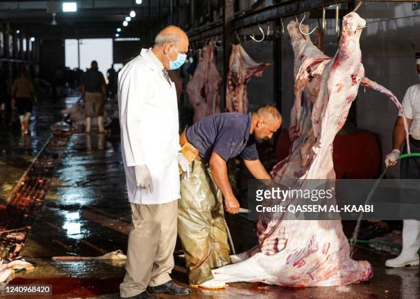 Fares Mansour, director of Najaf Veterinary Hospital, supervises the work at a slaughterhouse in the central Iraqi city of Najaf, before labelling a...