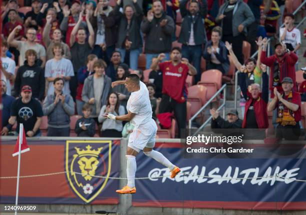 Bobby Wood of Real Salt Lake jumps over a rope line as he celebrates with the crowd after scoring a goal against the Houston Dynamo during the first...