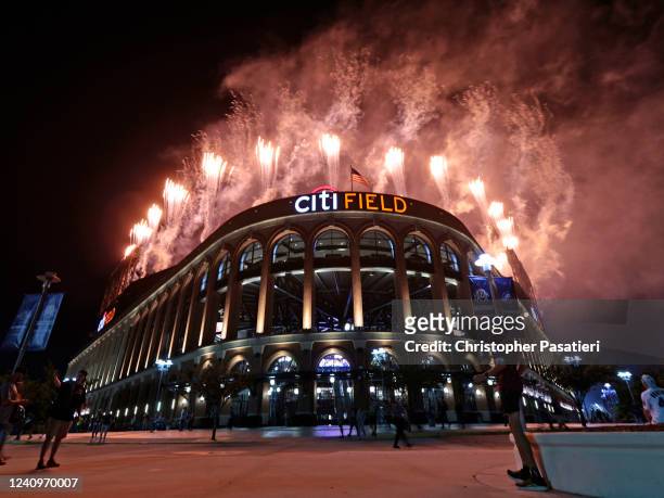 Fans watch as pyrotechnics illuminate the night sky above Citi Field after the game between the Philadelphia Phillies and New York Mets on May 28,...