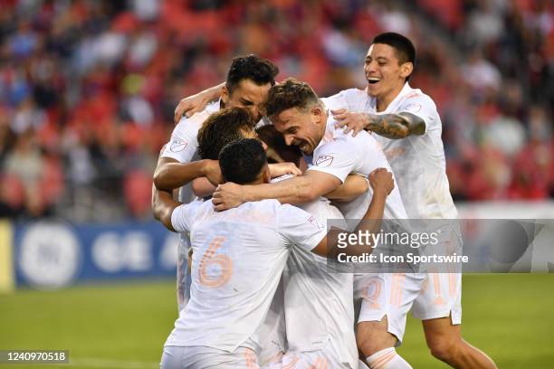 The Chicago Fire players celebrate by embracing Chicago Fire forward Kacper Przybyko after his goal in the second half during the MLS Soccer regular...