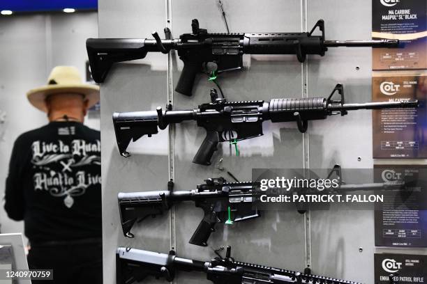 Colt M4 Carbine and AR-15 style rifles are displayed during the National Rifle Association Annual Meeting at the George R. Brown Convention Center,...