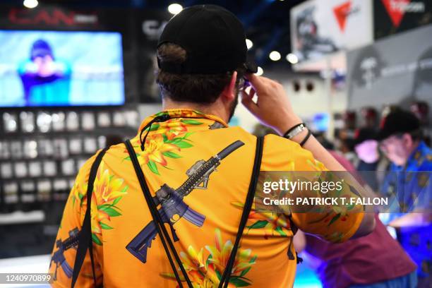 An attendee wears a shirt featuring an AR-15 style rifle during the National Rifle Association Annual Meeting at the George R. Brown Convention...