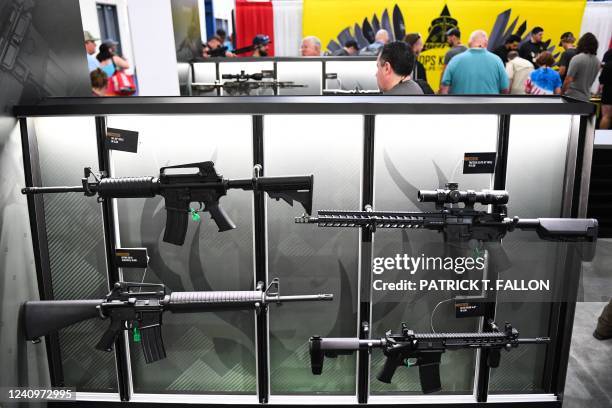 Attendees view a display of Stag Arms AR-15 style semi-automatic rifles during the National Rifle Association Annual Meeting at the George R. Brown...