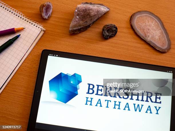 In this photo illustration Berkshire Hathaway Inc. Logo seen displayed on a tablet.