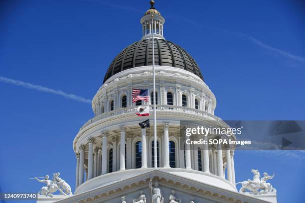 Flags of the United States and California fly at half-staff at California State Capitol Museum. President of the United States, Joe Biden ordered...