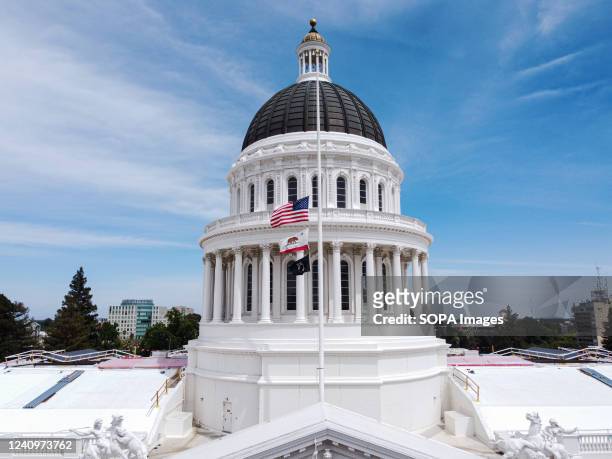 Flags of the United States and California fly at half-staff at California State Capitol Museum. President of the United States, Joe Biden ordered...