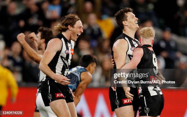 Nathan Murphy of the Magpies, Brody Mihocek of the Magpies and John Noble of the Magpies celebrate after the final siren during the 2022 AFL Round 11...