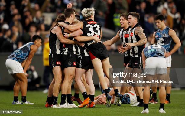 Collingwood players celebrate after the final siren during the 2022 AFL Round 11 match between the Collingwood Magpies and the Carlton Blues at the...