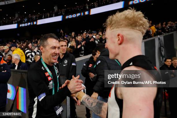 Craig McRae, Senior Coach of the Magpies celebrates with John Noble of the Magpies during the 2022 AFL Round 11 match between the Collingwood Magpies...