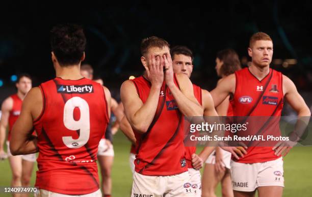 Dyson Heppell of the Bombers covers his face after the loss during the 2022 AFL Round 11 match between the Port Adelaide Power and the Essendon...