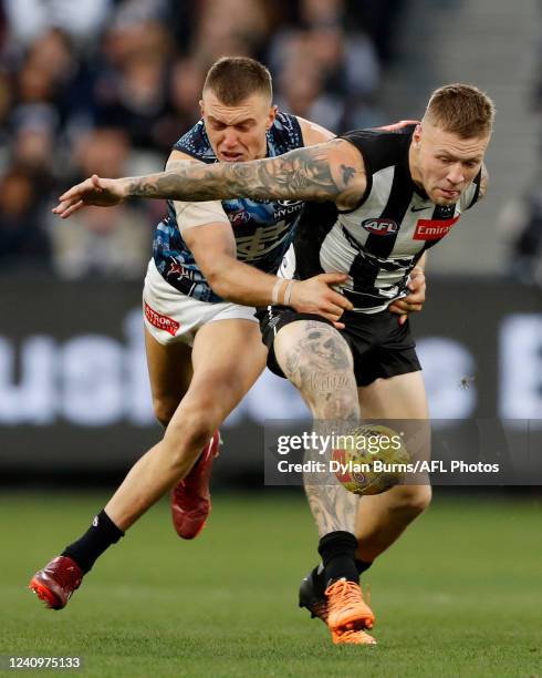 Patrick Cripps of the Blues and Jordan De Goey of the Magpies compete for the ball during the 2022 AFL Round 11 match between the Collingwood Magpies...