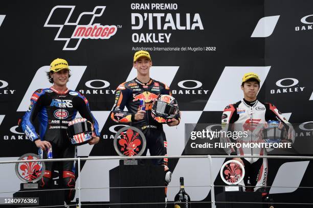 Second-placed USA's Joe Roberts, race winner Spain's Pedro Acosta and third-placed Japan's Ai Ogura pose on the podium after competing in the Moto 2...