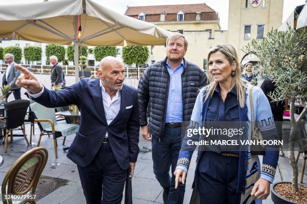 Netherland's King Willem-Alexander and Queen Maxima walk with the Mayor of Valkenburg Daan Prevoo , as they visit the Grotestraat, following flooding...