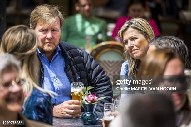 Netherland's King Willem-Alexander and Queen Maxima speak with entrepreneurs in the Grotestraat, about the consequences of flooding a year ago, in...