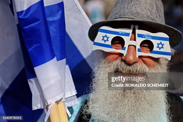 Man wearing spectacle frames depicting the Israeli flag looks on during a demonstration in Jerusalem on May 29 ahead of the 'flags march' to mark...