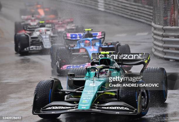 Aston Martin's German driver Sebastian Vettel drives in the rain during a formation lap ahead of a delayed race start at the Monaco Formula 1 Grand...