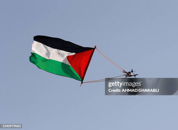 Palestinian flag hanging from a civilian drone flies over Jerusalem on May 29 during the Israeli 'flags march' to mark "Jerusalem Day". - Jerusalem...