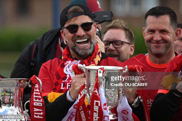 Liverpool's German manager Jurgen Klopp celebrates with the League cup trophy from an open-top bus during a parade through the streets of Liverpool...