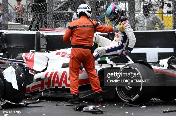 Haas F1 Team's German driver Mick Schumacher is asisted by a race marshal after crashing during the Monaco Formula 1 Grand Prix at the Monaco street...