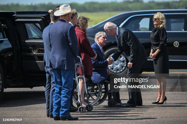 President Joe Biden and First Lady Jill Biden greet Texas Governor Greg Abbott and others as they arrive at Garner Field Airport in Uvalde, Texas on...