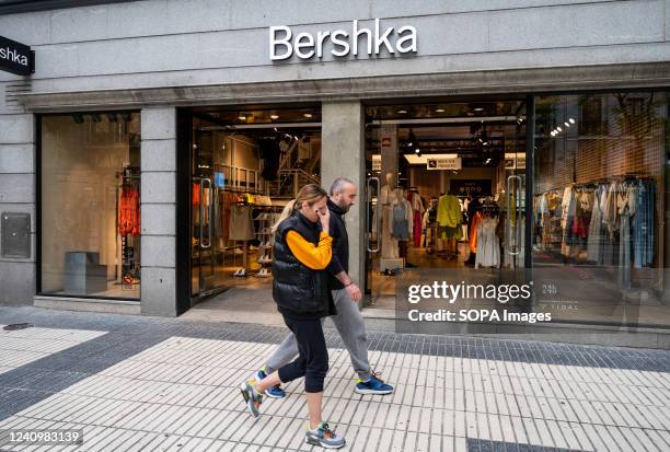 Pedestrians walk past the Spanish fashion brand owned by Inditex, Bershka, store in Spain.