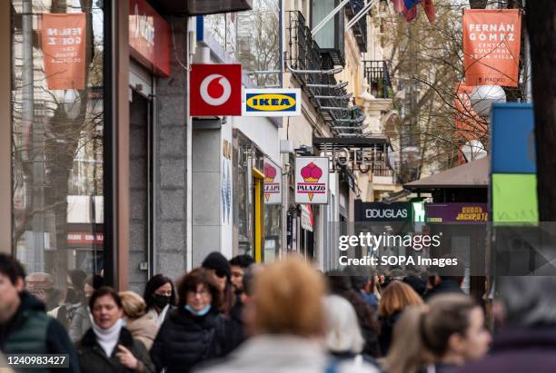 Pedestrians walk past the Swedish furniture company Ikea and British multinational telecommunications corporation and phone operator Vodafone stores...