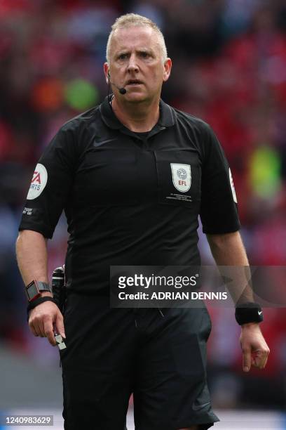 English referee Jonathan Moss reacts during the English Championship play-off final football match between Huddersfield Town and Nottingham Forest at...