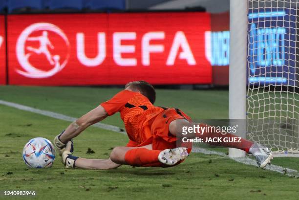 France's goalkeeper Lisandru Olmeta saves a penalty during the 2022 UEFA European Under-17 Championship semi-final football match between France and...
