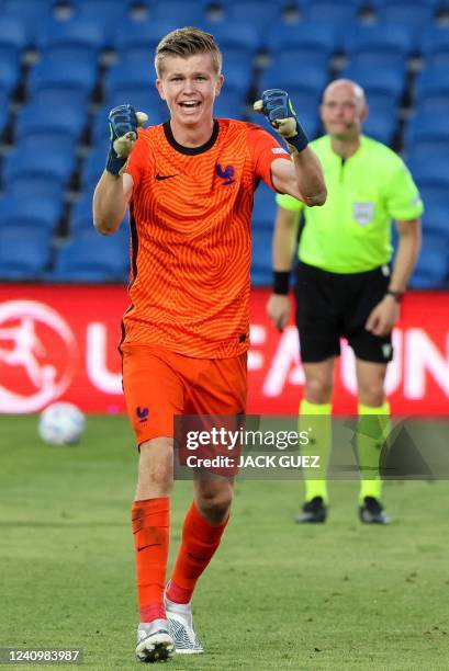 France's goalkeeper Lisandru Olmeta celebrates a penalty save during the 2022 UEFA European Under-17 Championship semi-final football match between...