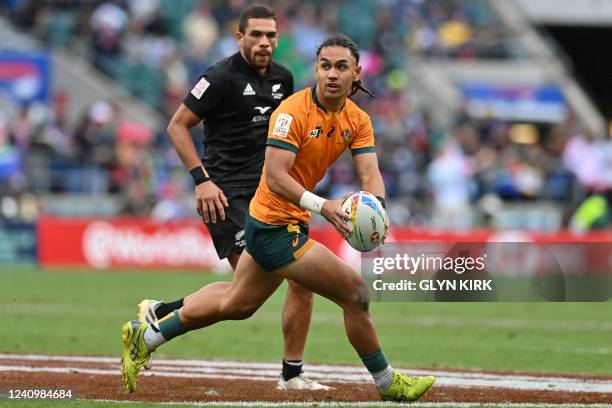 Australia's Dietrich Roache looks to pass the ball during the Cup Final rugby union match between New Zealand and Australia on the second day of the...