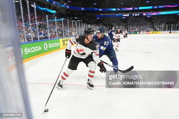 Canada's forward Cole Sillinger and Finland's defender Esa Lindell vie for the puck during the IIHF Ice Hockey World Championships final match...