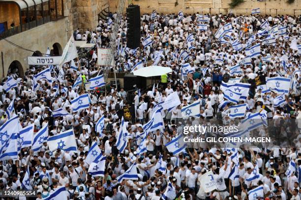 Demonstrators gather with Israeli flags near the Western Wall in the old city of Jerusalem on May 29 during the Israeli 'flags march' to mark...