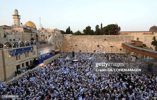 Demonstrators gather with Israeli flags at the Western Wall in the old city of Jerusalem on May 29 during the Israeli 'flags march' to mark...