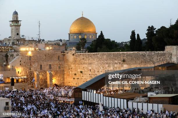 Demonstrators gather with Israeli flags at the Western Wall in the old city of Jerusalem on May 29 during the Israeli 'flags march' to mark...