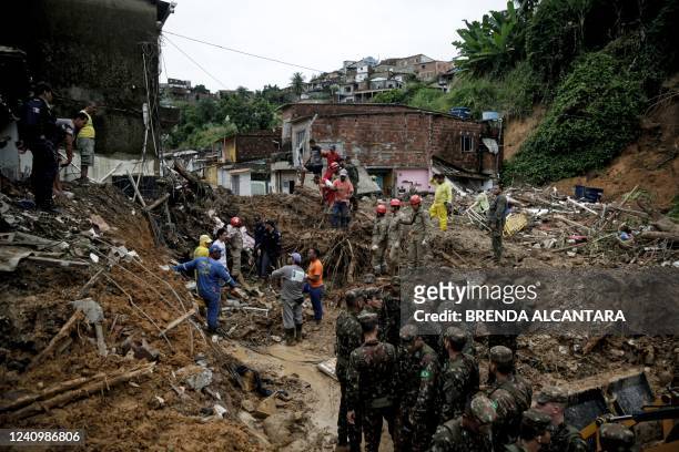 Soldiers, firefighters and residents search for victims a day after a landslide in the community Jardim Monte Verde, Ibura neighbourhood, in Recife,...