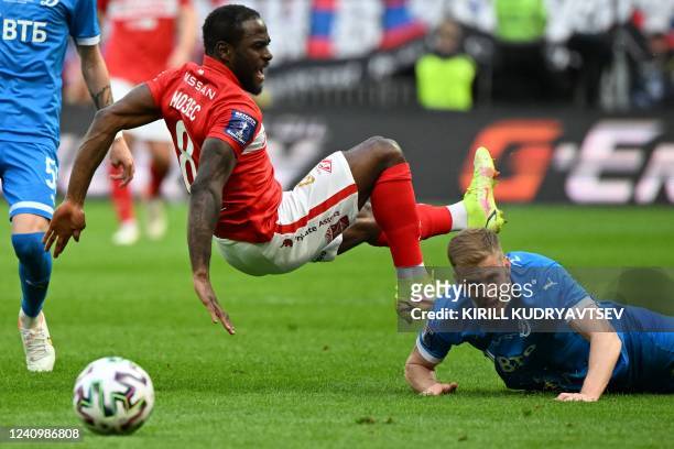 Spartak Moscow's Nigerian defender Victor Moses falls past Dynamo Moscow's Russian midfielder Daniil Fomin during during the Russian Cup final...