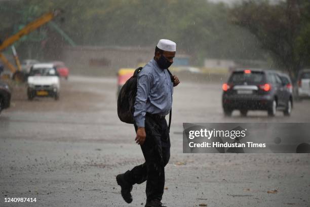 Commuters caught in the rain on Delhi-Gurugram road near Atul Kataria Chowk, on May 29, 2022 in Gurugram, India.