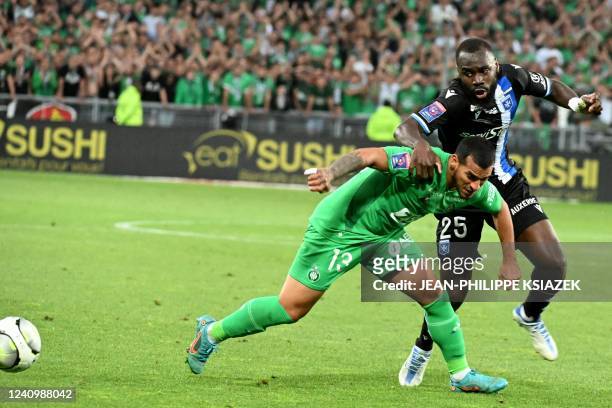 Saint-Etienne's Peruvian defender Miguel Trauco is challenged by Auxerre's Malian forward Lassine Sinayoko during the French L1-L2 play-off second...