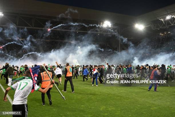 Saint-Etienne's fans invade the pitch after being defeated at the end of the French L1-L2 play-off second leg football match between AS Saint-Etienne...