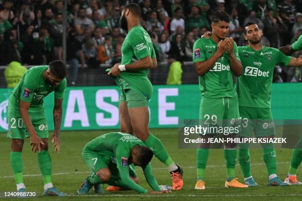 Saint-Etienne's French midfielder Aimen Moueffek and teammates react after being defeated by Auxerre at the end of the French L1-L2 play-off second...