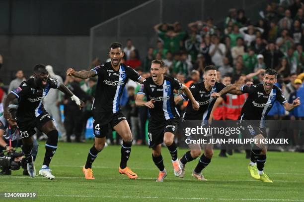Auxerre's Brazilian defender Jubal and teammates celebrate their vitory at the end of the French L1-L2 play-off second leg football match between AS...