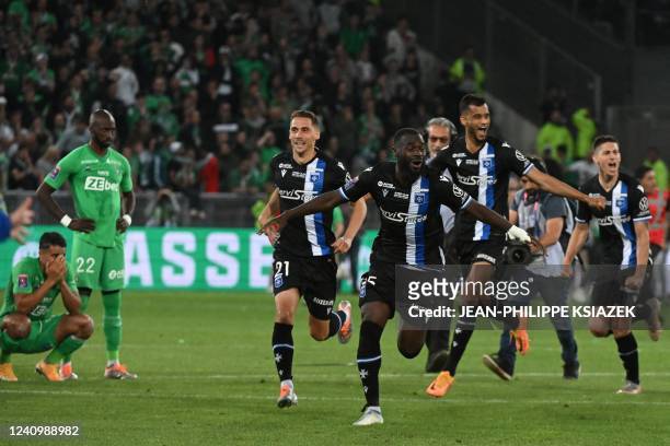 Auxerre's players celebrate their vitory at the end of the French L1-L2 play-off second leg football match between AS Saint-Etienne and AJ Auxerre at...