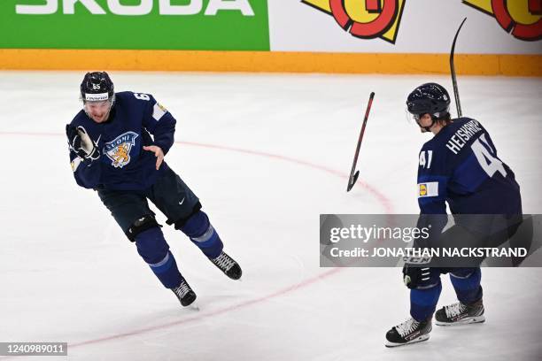 Finland's forward Sakari Manninen celbrates scoring the winning goal with his temmate Finland's defender Miro Heiskanen during the IIHF Ice Hockey...