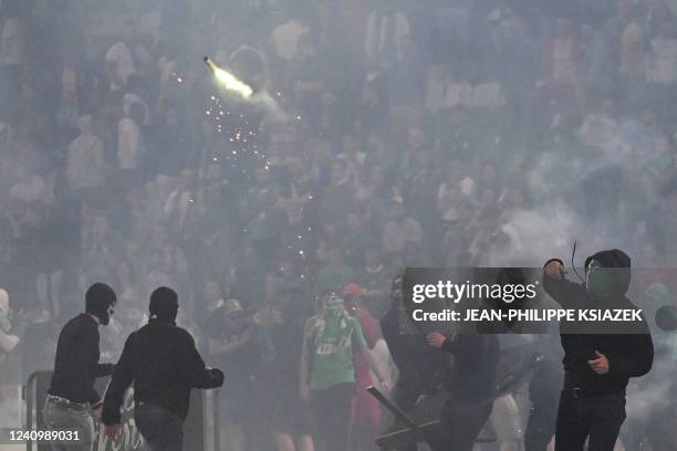 Saint-Etienne's fan throws a projectile on the pitch after being defeated by Auxerre at the end of the French L1-L2 play-off second leg football...