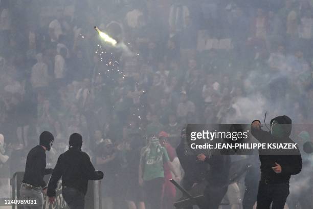Saint-Etienne's fan throws a projectile on the pitch after being defeated by Auxerre at the end of the French L1-L2 play-off second leg football...