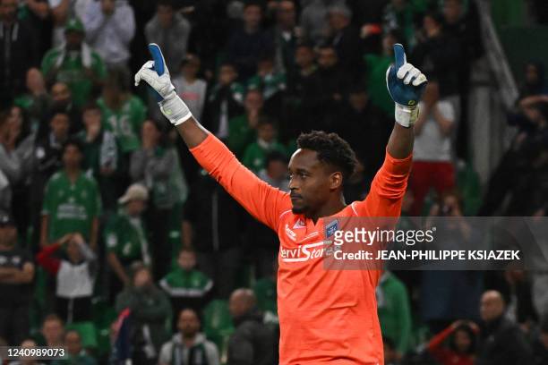 Auxerre's French goalkeeper Donovan Leon celebrates after making a save qualifying his team during the penalty shoot-out at the end of the French...