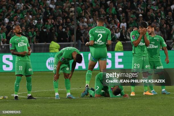 Saint-Etienne's Brazilian defender Gabriel Silva and teammates react after being defeated by Auxerre at the end of the French L1-L2 play-off second...