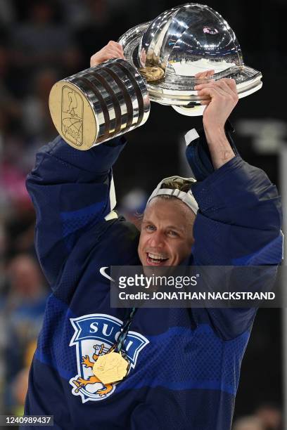 Finland's forward Toni Rajala celebrates with the trophy after the IIHF Ice Hockey World Championships final match between Finland and Canada in...