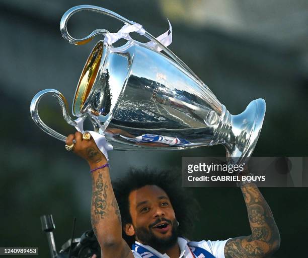 Real Madrid's Brazilian defender Marcelo lifts their trophy at the Cibeles square on May 29 a day after beating Liverpool in the UEFA Champions...